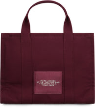 Load image into Gallery viewer, La traduzione di "The Canvas Medium Tote Bag" in italiano è "La borsa a tracolla in tela di media grandezza".
